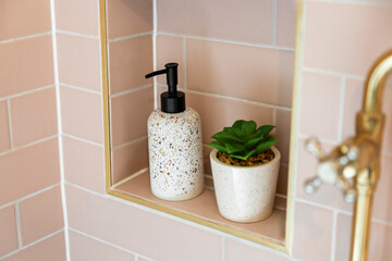 Ceramic Accessories Set in a Light Pink Tiled Shower Niche - obrazy, fototapety, plakaty