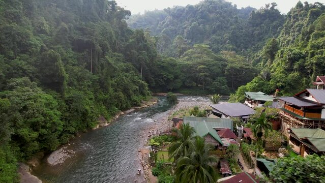 An aerial drone view of the Bukit Lawang river in Bukit Lawang, Sumatra. This river borders the Sumatran jungle in Indonesia. 
