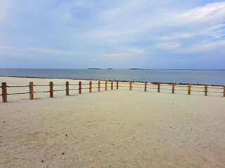 Jakarta, Indonesia - January 30th 2024 : "Pantai Indah Kapuk Aloha" atmosphere with white sand, sea and blue sky