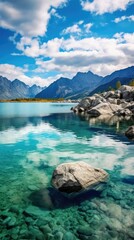 Captivating View of a Sunny Day in the Mountains, Deep Blue Sky, Water Nestled Among the Mountains Reflecting Sky and Clouds, Peaceful Evening, Lake Water