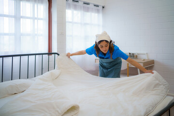 Housekeeper Making the Bed with Precision