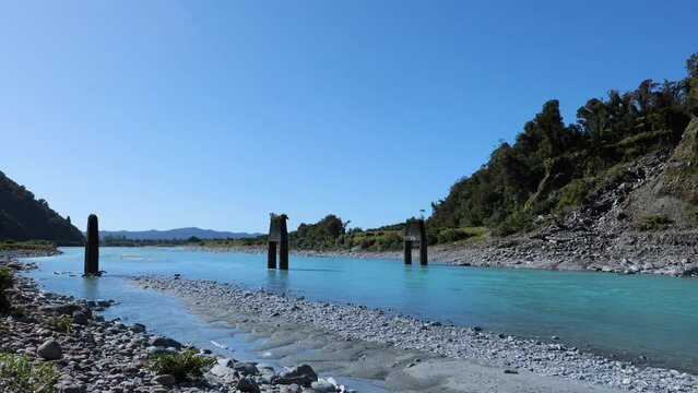 Camera pan at the Whataroa river. Old bridge. New Zealand