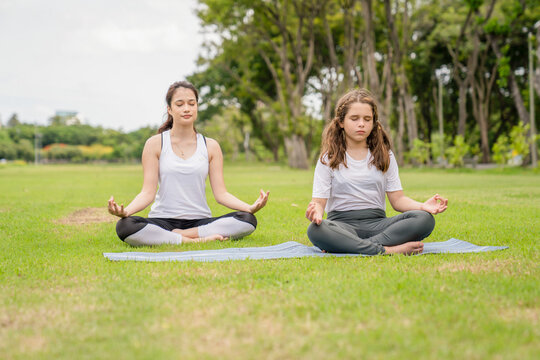 Happy smiling, Yoga teacher class relax in the park. Healthy lifestyle, teaching and learning, and sports concepts. recreation and sporty young people concept.