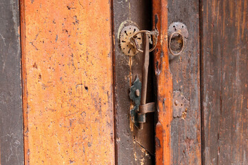 Close up of wooden door and antique metal door latch in Topkapi Palace, Istanbul, Turkey 