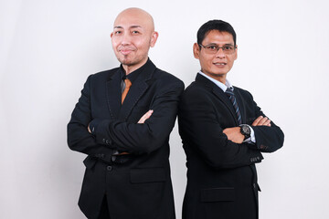 Two Asian business partners standing together in white background