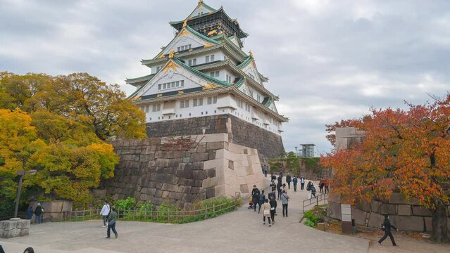 2019-11-26 JAPAN : Time lapse of Osaka Castle building with colorful maple leaves or fall foliage in autumn season. Colorful trees, Kyoto City, Kansai, Japan. Architecture landscape background. 