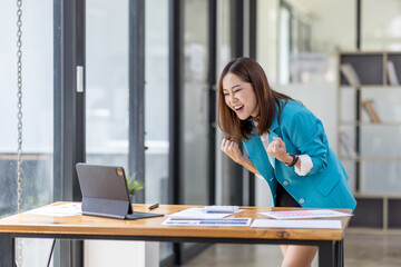 Excited Happy asian woman sit at desk feel euphoric win online, happy asian woman overjoyed get...