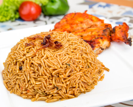 Chicken Bukhari mandi biryani rce pilaf with fried onion served in dish isolated on table top view of arabic food