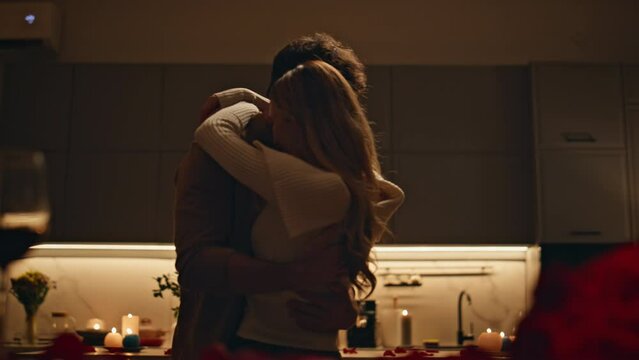 Tender lovers dancing dark kitchen closeup. Happy couple hugging on evening date