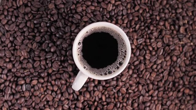 close up video of a cup of coffee with coffee beans