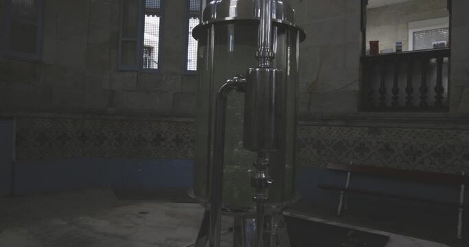 Clear glass water tank container with bubbles. Industrial mineral filtration system station plant. 