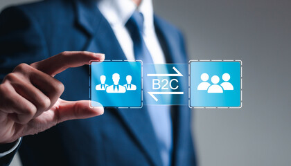 B2C, Business to customer marketing strategy concept. Businessman holding virtual B2C icon for...