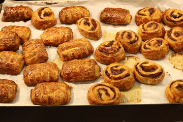 Bread and bakery products lie on display in a store.