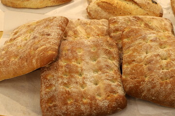 Bread and bakery products lie on display in a store.