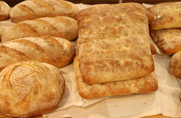 Bread and bakery products lie on display in a store.
