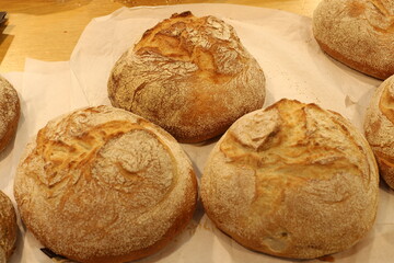 Bread and bakery products lie on display in a store.