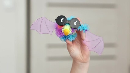 In the child's hand is a winged monster with eyes made of bunchems constructor.