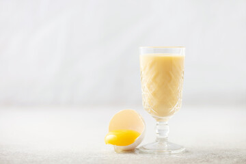 Egg alcohol liquor in a glass. Festive drink.