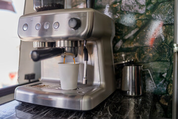 Coffee maker pouring coffee in a food truck