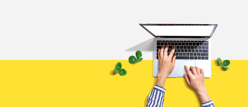 Laptop computer with shamrock leaves - flat lay