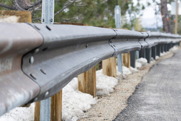 Guard on mountain road with snow in background.  