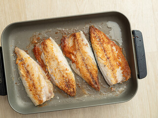 Grilled mackerel in a pan	