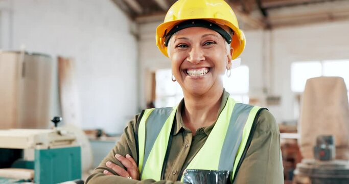 Face, mature engineer or happy woman with arms crossed in woodwork workshop. Portrait, smile or confident professional architect, contractor or supervisor in helmet at factory for carpentry in Brazil