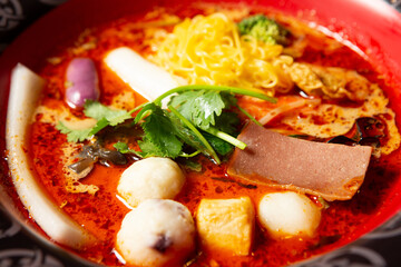 skewered vegetables and meat cooked in a hot and spicy soup