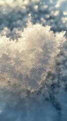 Snow crystals form a heart shape on the icy surface, close up photo, top view, sunny winter day