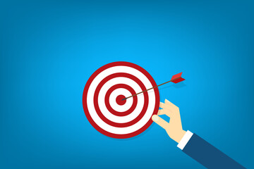 Hand holding a target, showing a goal. Red arrow hits the center. Business challenge failure and success concept.	
