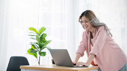Portrait beautiful business asian creative pink suit woman online work office desk use computer...