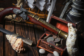 Pirate concept background front view. Sea ship, treasure chest with a coins and musket gun on the...