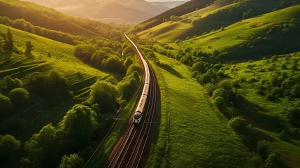 Kussenhoes drone view photography of train driving on the train tracks along the green hills © azone