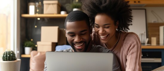 Joyful couple gleefully purchasing decorations online while settling into their new home.