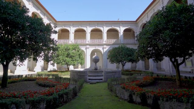 A cloister garden inside a Portuguese monastery, called 'Santa Mafalda de Arouca Monastery,' featuring a  stone monument , situated in Arouca.