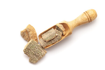 Top view of Organic Vauna Barks (Crataeva nurvala), in a wooden scoop. Isolated on a white background.