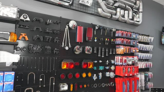 The interior of a modern car and truck parts store with displays of tools, accessories, repair and maintenance parts for sale