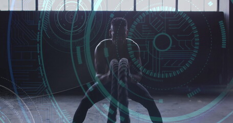 Image of microprocessor connections over man exercising with ropes