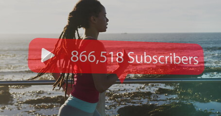 Image of rising number of subscribers over woman jogging on promenade by the sea
