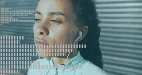 Music equalizer against close up of african american woman wearing earphones