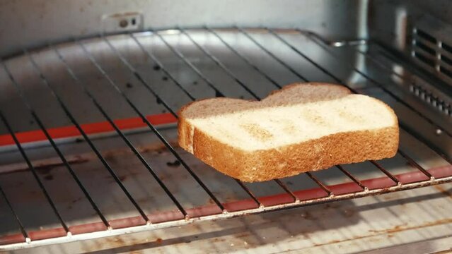 Flipping bread in a toaster oven 