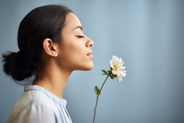 profile of girl smelling bloom - obrazy, fototapety, plakaty