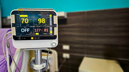 Vital signs monitor showing Heart rate and blood pressure of patient in patient room. Electrocardiogram, EKG, heart rate monitor in hospital room for checking heart rate hospitalized patients.