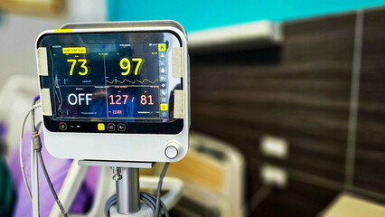 Vital signs monitor showing Heart rate and blood pressure of patient in patient room....