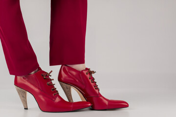 women's shoes. female legs in red wide trousers and red high-heeled shoes, fashion concept