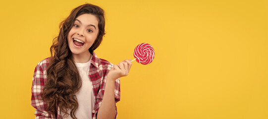 lollipop child. hipster kid with long curly hair hold lollypop. sugar candy on stick. Teenager...