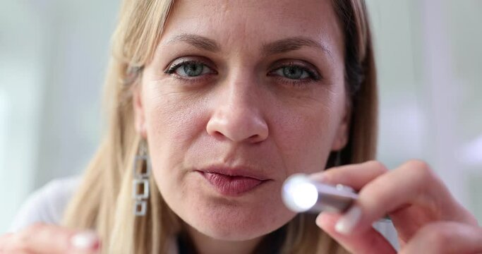 ENT specialist holds flashlight and throat otolaryngology kit in hands