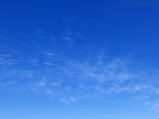blue sky with tiny small white clouds