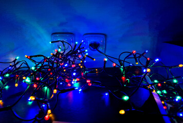 chains of light on a dark blue background resemble a starry sky at night. display stand with...