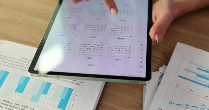 Tablet in hands of woman and calendar application
